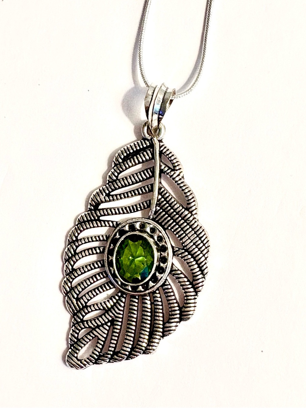 2 1/2 inch, 925 marked , leaf shaped, Peridot pendant on a silver chain.